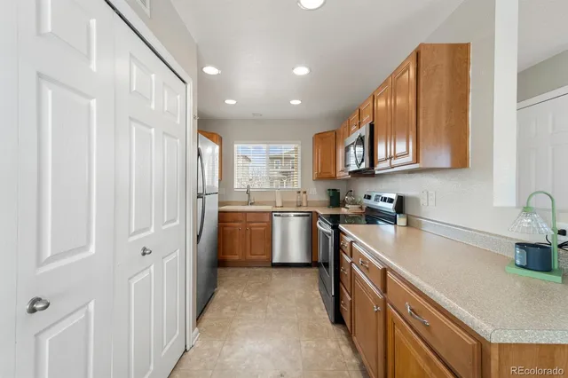a kitchen with a sink stove and refrigerator