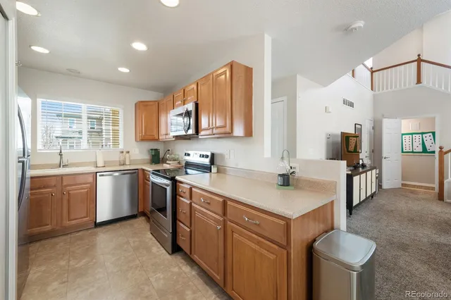 a kitchen with a sink stove and cabinets