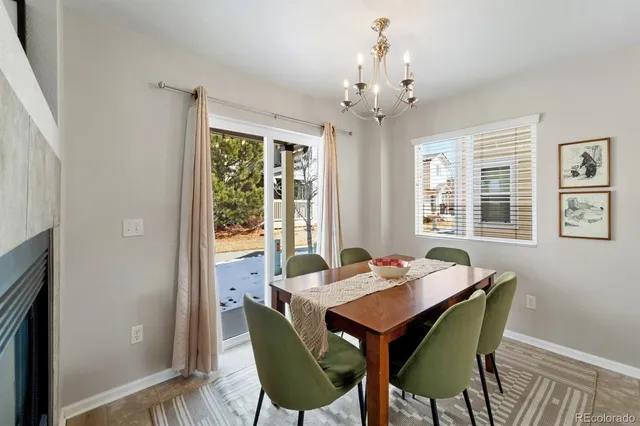 a dining room with furniture a chandelier and wooden floor