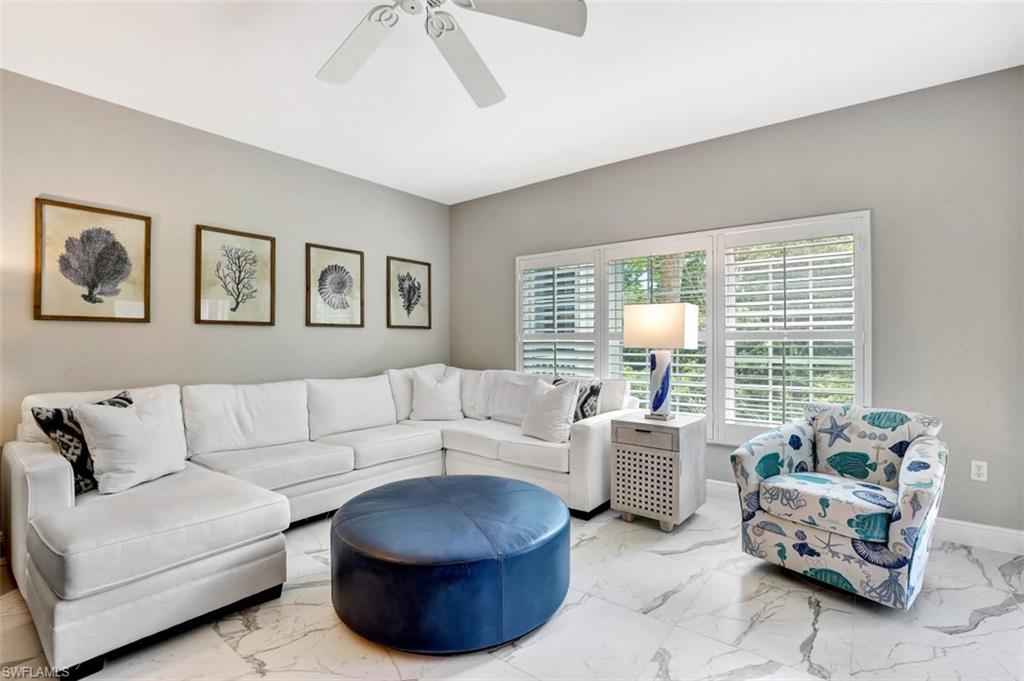 5897 Chanteclair Drive, Unit 314 Naples, FL 34108 - Photo 13 of 20 a living room with furniture and a large window