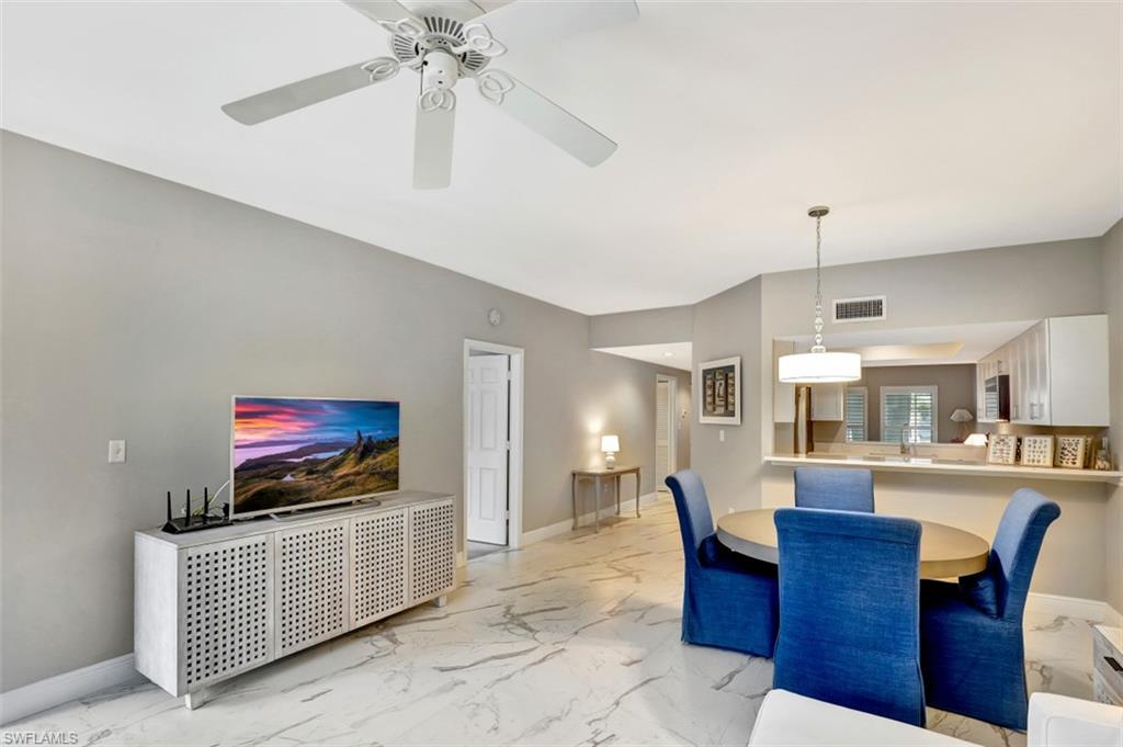 5897 Chanteclair Drive, Unit 314 Naples, FL 34108 - Photo 14 of 20 a living room with furniture and a flat screen tv