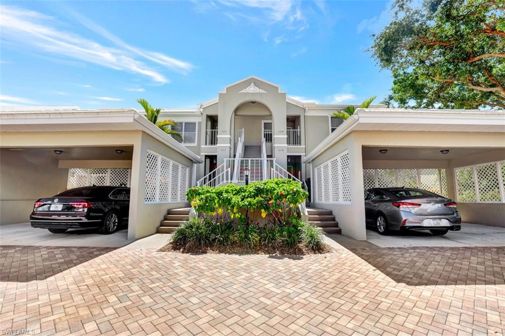 5897 Chanteclair Drive, Unit 314 Naples, FL 34108 - Photo 17 of 20 a view of a car parked in front of a house