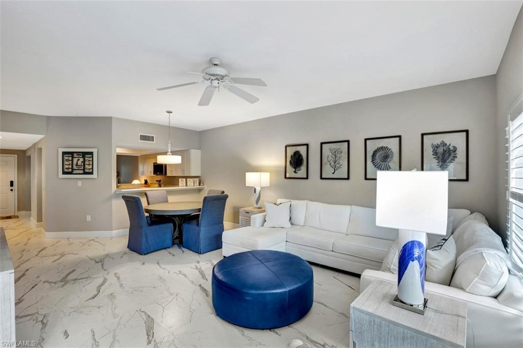 5897 Chanteclair Drive, Unit 314 Naples, FL 34108 - Photo 2 of 20 a living room with furniture and kitchen view