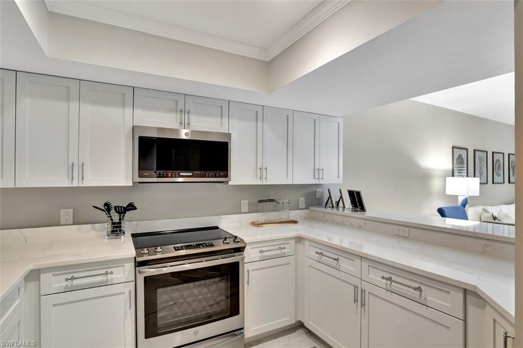 5897 Chanteclair Drive, Unit 314 Naples, FL 34108 - Photo 3 of 20 a kitchen with a sink stove and microwave