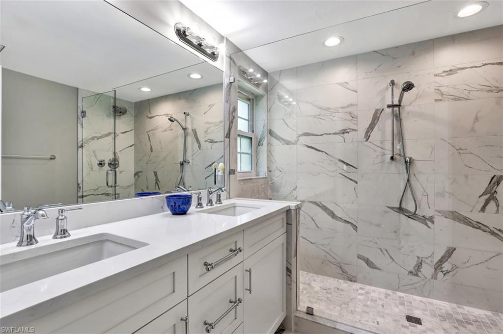 5897 Chanteclair Drive, Unit 314 Naples, FL 34108 - Photo 6 of 20 a bathroom with a double vanity sink mirror and double