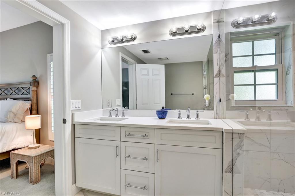 5897 Chanteclair Drive, Unit 314 Naples, FL 34108 - Photo 7 of 20 a spacious bathroom with a double vanity sink mirror and toilet