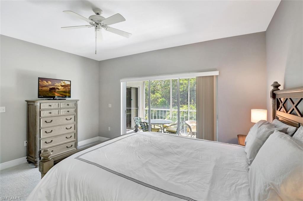 5897 Chanteclair Drive, Unit 314 Naples, FL 34108 - Photo 9 of 20 a bedroom with a large bed and a tv