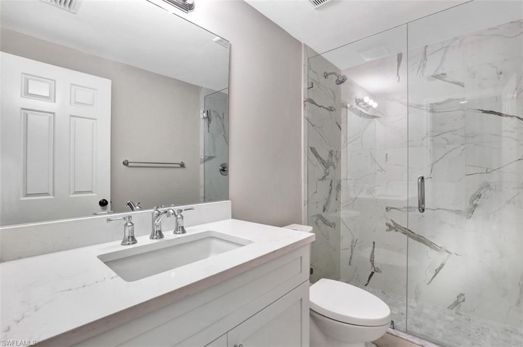 5897 Chanteclair Drive, Unit 314 Naples, FL 34108 - Photo 10 of 20 a bathroom with a sink toilet vanity and shower