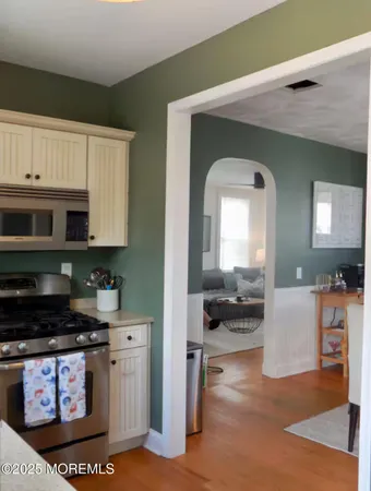 a kitchen with stainless steel appliances granite countertop a stove a sink and a microwave