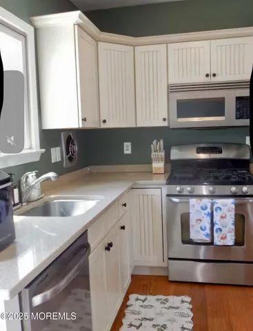 a bedroom with a bed and a large mirror