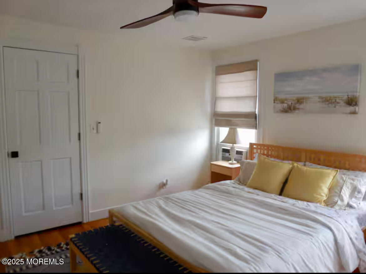 24 Philadelphia Avenue Lavallette, NJ 08735 - Photo 23 of 41 a bedroom with a bed and wooden floor