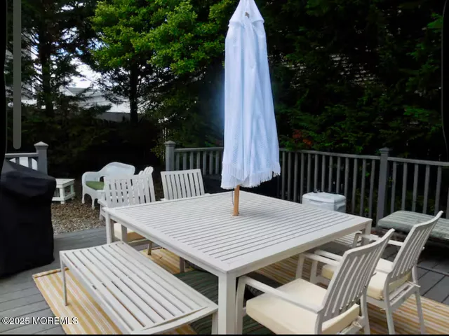 a view of a patio with table and chairs
