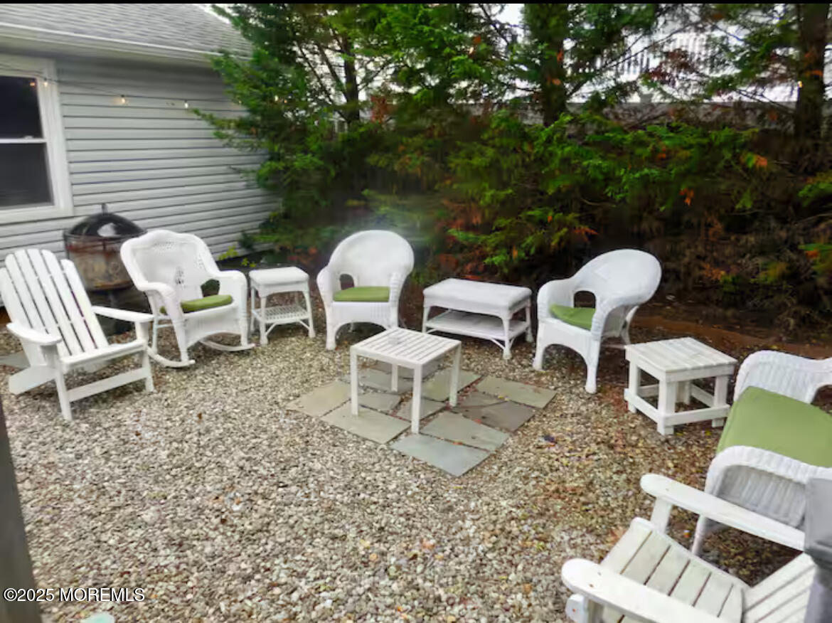 24 Philadelphia Avenue Lavallette, NJ 08735 - Photo 37 of 41 a view of a chairs and table in backyard
