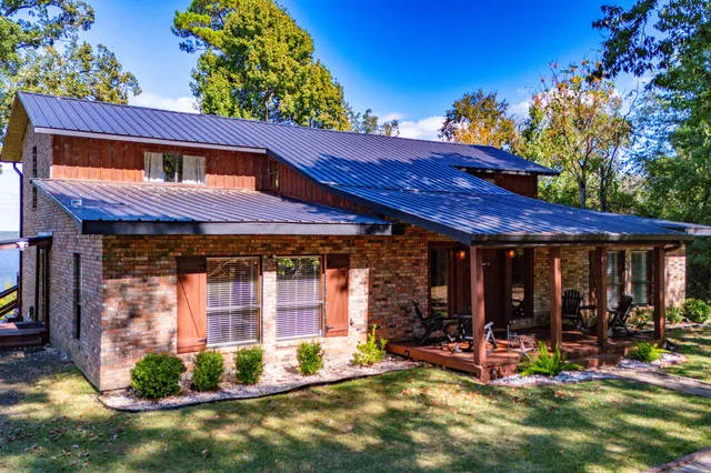 a view of wooden house with chairs in front of house