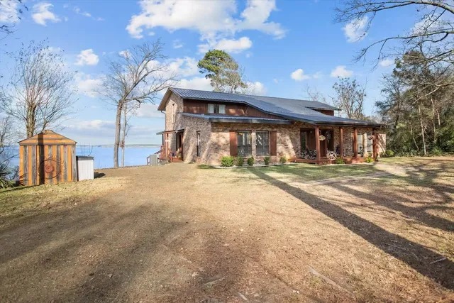 a view of a deck with a table and chairs under an umbrella