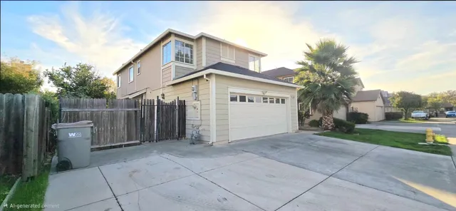 a view of a grey house with a yard