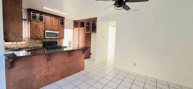 a view of a kitchen with microwave and cabinets