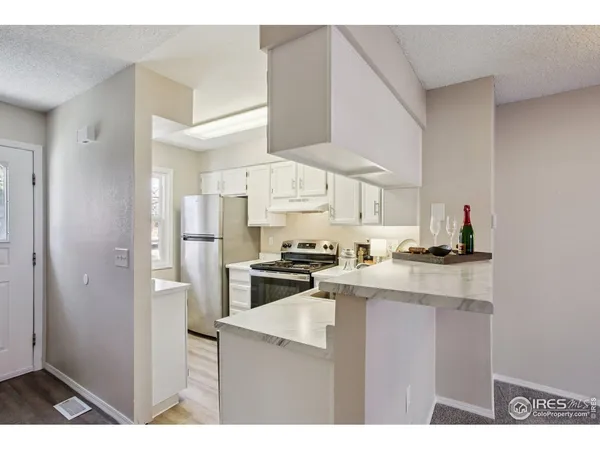 a kitchen with a sink a stove and refrigerator