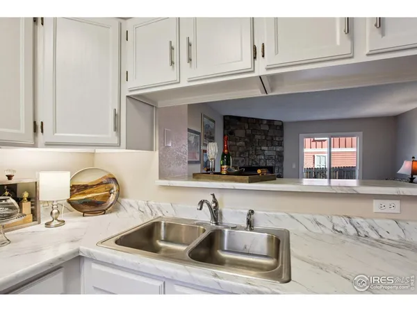 a kitchen with granite countertop a sink and a stove