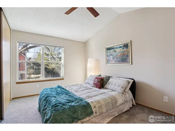 a bedroom with a bed and a painting on the wall