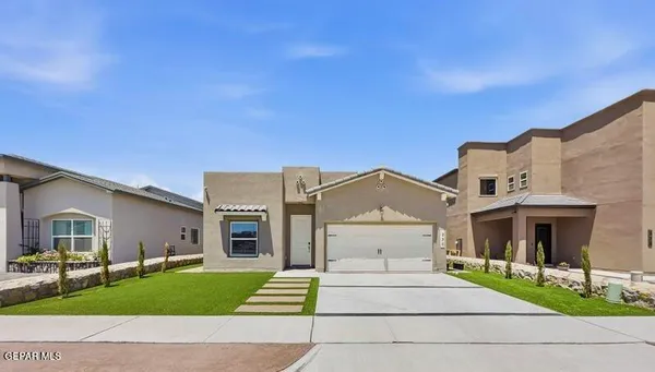 a front view of a house with a garden and yard