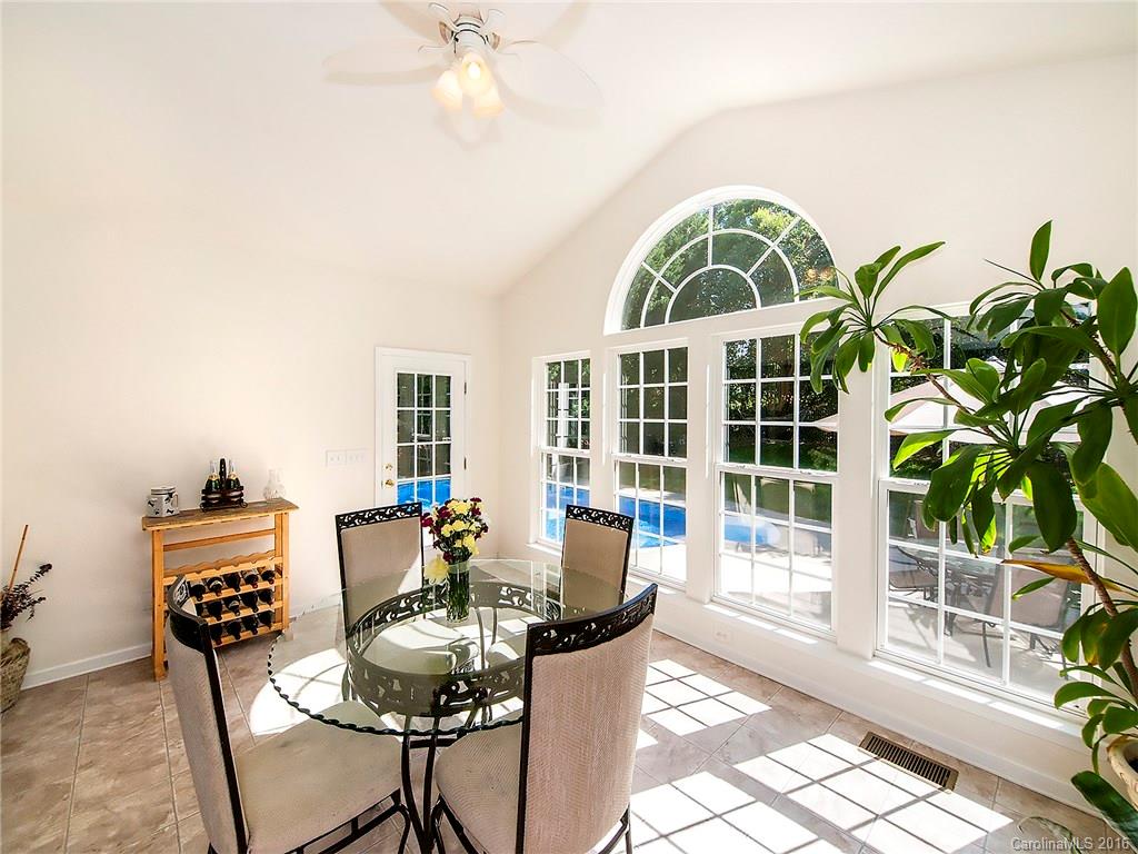 748 Drew Avenue Fort Mill, SC 29708 - Photo 11 of 23 a dining room with furniture a potted plant and a chandelier