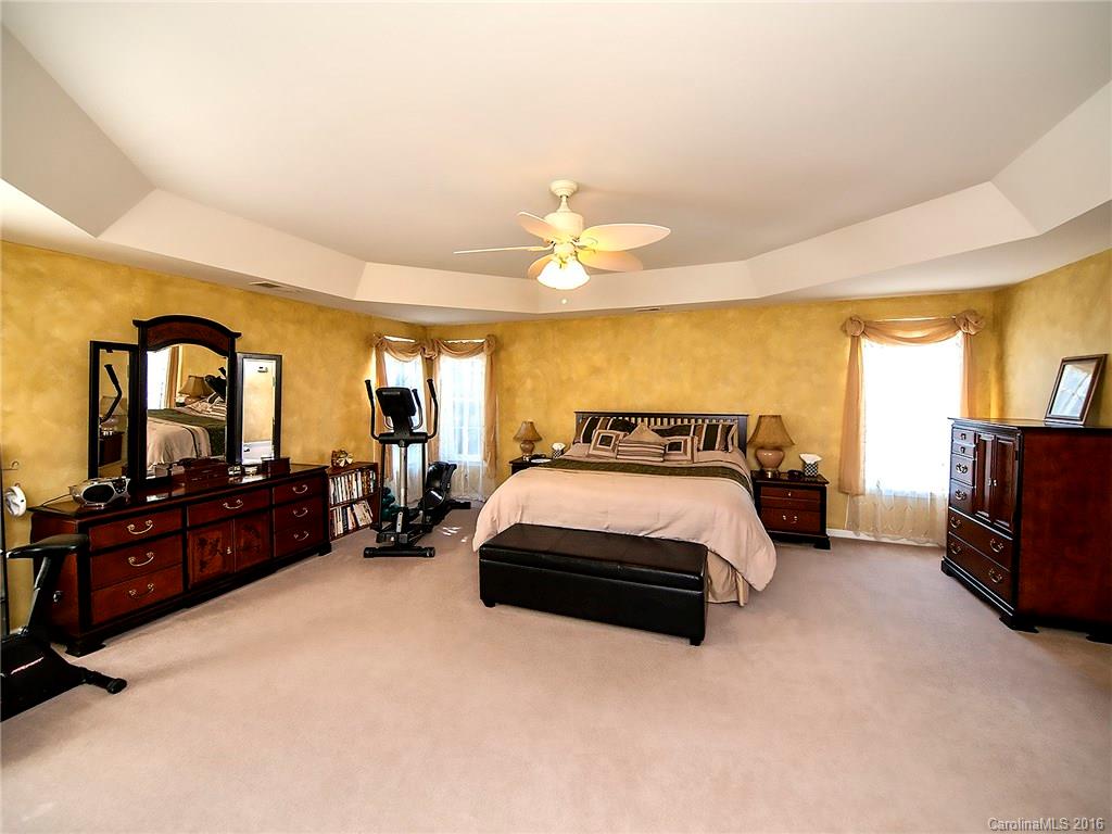 748 Drew Avenue Fort Mill, SC 29708 - Photo 13 of 23 a spacious bedroom with a bed a couch and dresser