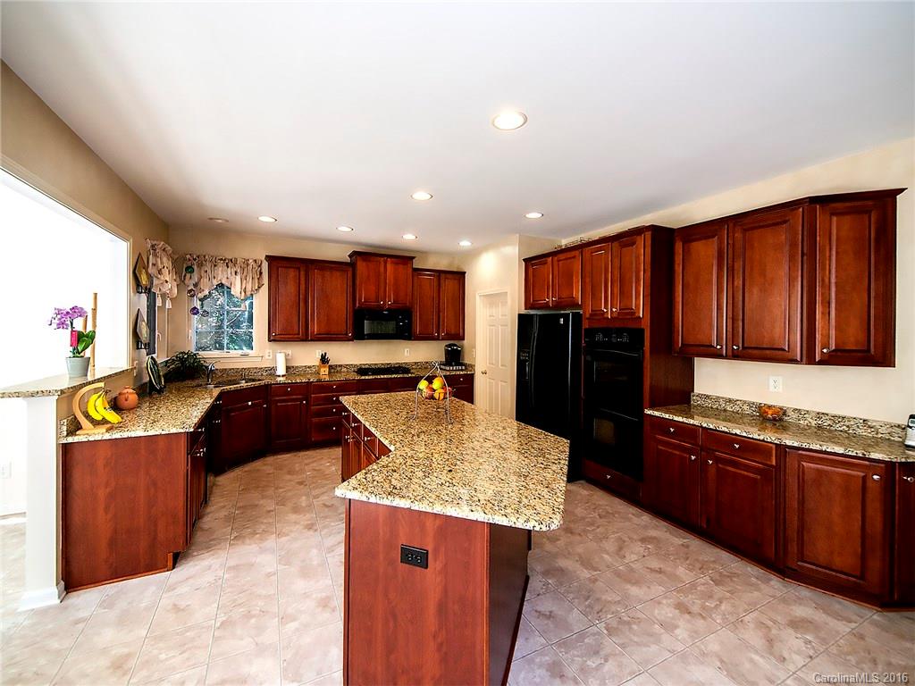 748 Drew Avenue Fort Mill, SC 29708 - Photo 6 of 23 a kitchen with stainless steel appliances kitchen island granite countertop a stove refrigerator and a sink