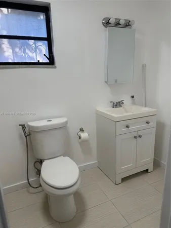 a white toilet sitting next to a bathroom sink