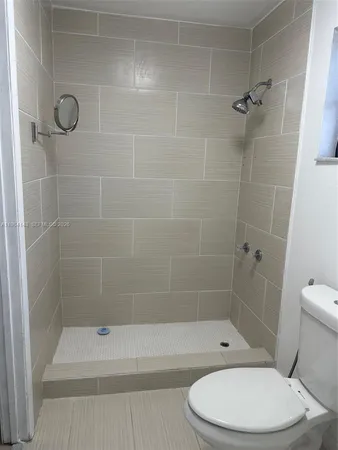 a bathroom with a toilet and shower