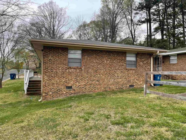 a view of house with backyard