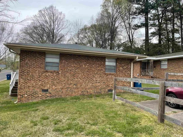 a kitchen with a sink a stove cabinets and wooden floor