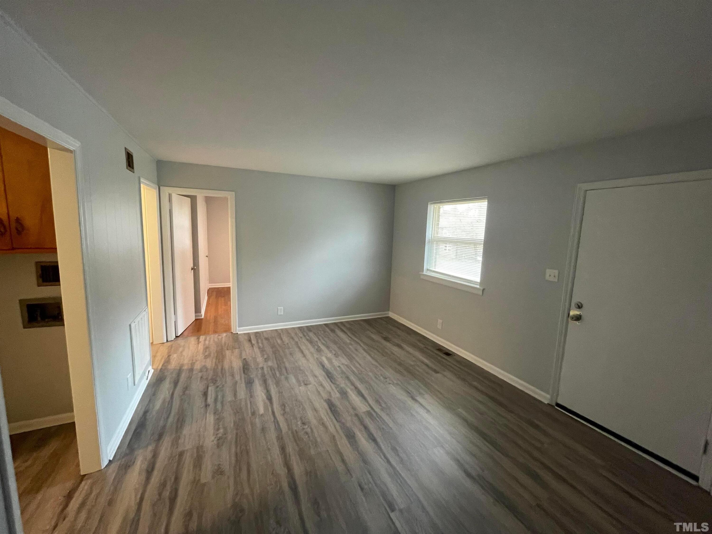 334 Clark Street, Unit A Durham, NC 27701 - Photo 10 of 16 an empty room with wooden floor and windows
