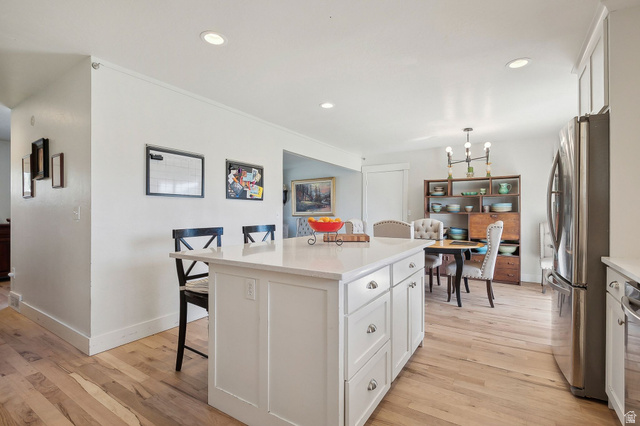550 Pine Canyon Road Midway, UT 84049 - Photo 13 of 44 Kitchen island with white shaker-style cabinetry, a light-toned countertop, and recessed lighting