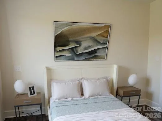 a bedroom with a bed and a chair