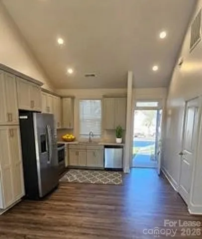 a kitchen with stainless steel appliances a refrigerator sink and microwave