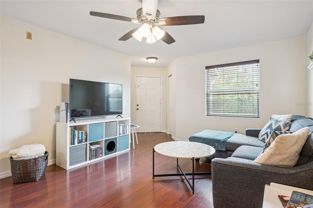 3032 Parkway Boulevard, Unit 305 Kissimmee, FL 34747 - Photo 5 of 40 a living room with furniture and a flat screen tv