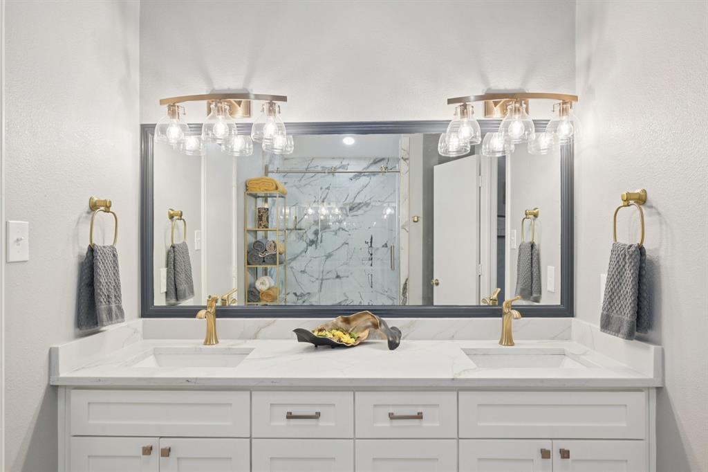 209 Cimarron Trail, Unit 6 Irving, TX 75063 - Photo 11 of 39 a bathroom with a double vanity sink and a mirror