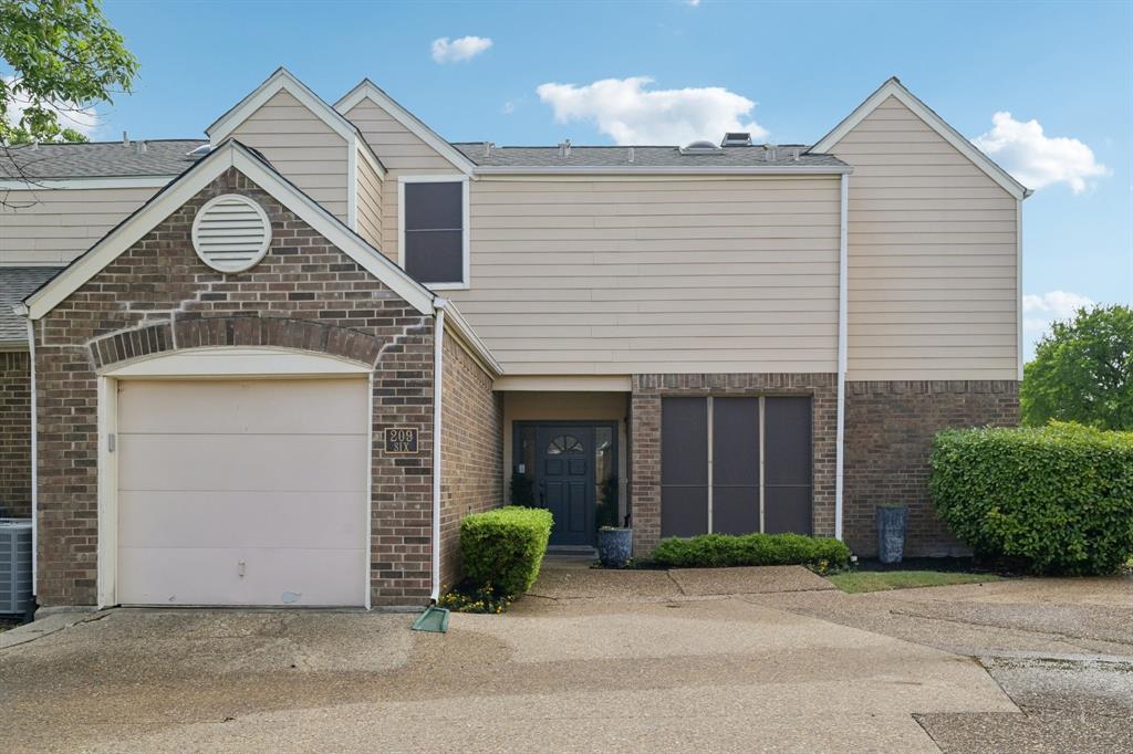 209 Cimarron Trail, Unit 6 Irving, TX 75063 - Photo 18 of 39 a view of a house with a yard and garage