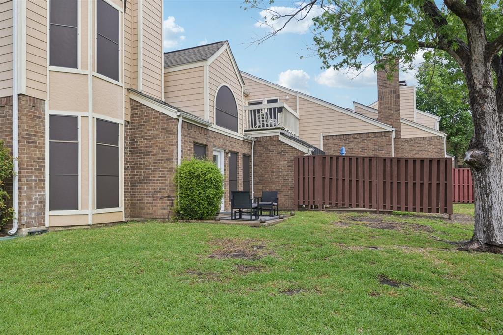 209 Cimarron Trail, Unit 6 Irving, TX 75063 - Photo 19 of 39 a front view of a house with yard and green space