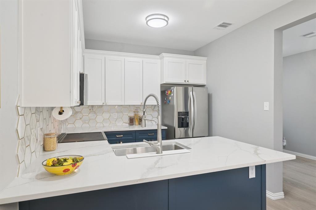 209 Cimarron Trail, Unit 6 Irving, TX 75063 - Photo 31 of 39 a kitchen with a sink a stove and refrigerator