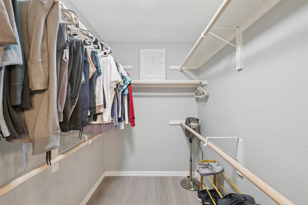 209 Cimarron Trail, Unit 6 Irving, TX 75063 - Photo 36 of 39 a view of walk in closet with clothes