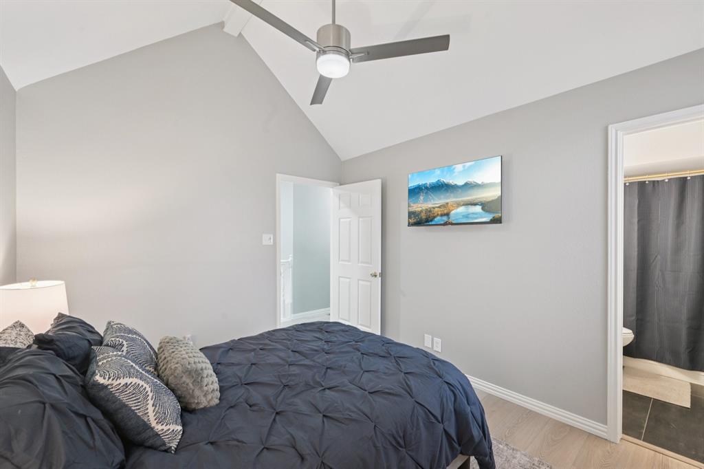 209 Cimarron Trail, Unit 6 Irving, TX 75063 - Photo 37 of 39 a bedroom with a bed and a window