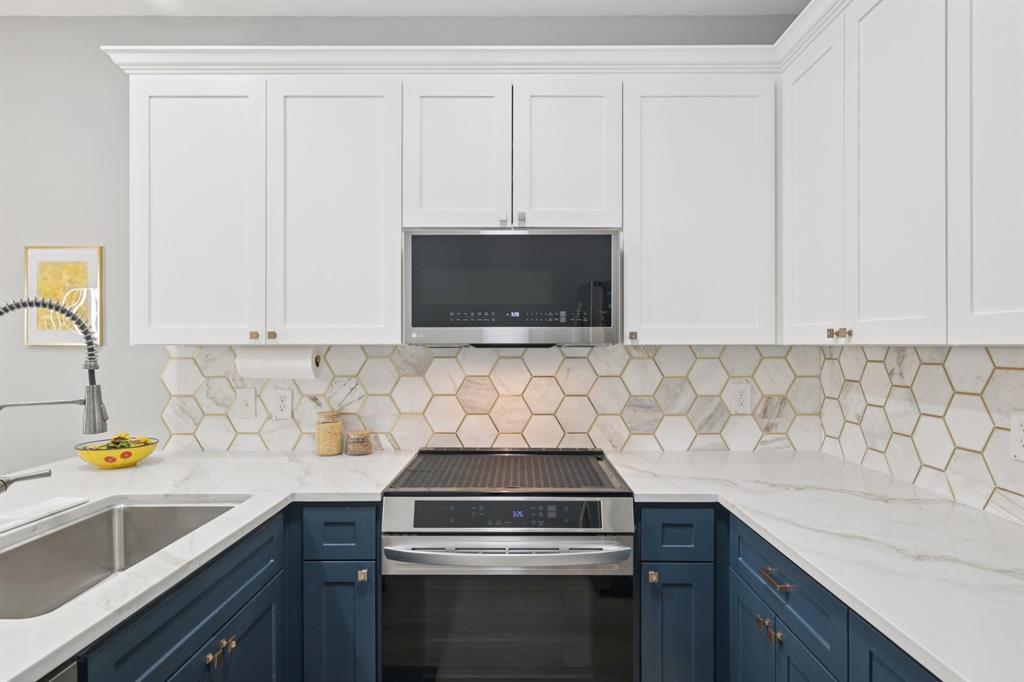 209 Cimarron Trail, Unit 6 Irving, TX 75063 - Photo 4 of 39 a kitchen with a sink stove and microwave
