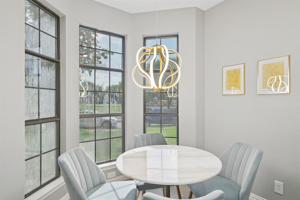 209 Cimarron Trail, Unit 6 Irving, TX 75063 - Photo 5 of 39 a view of a dining room with furniture and a potted plant