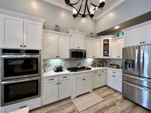 a kitchen with stainless steel appliances granite countertop a sink cabinets and stainless steel appliances