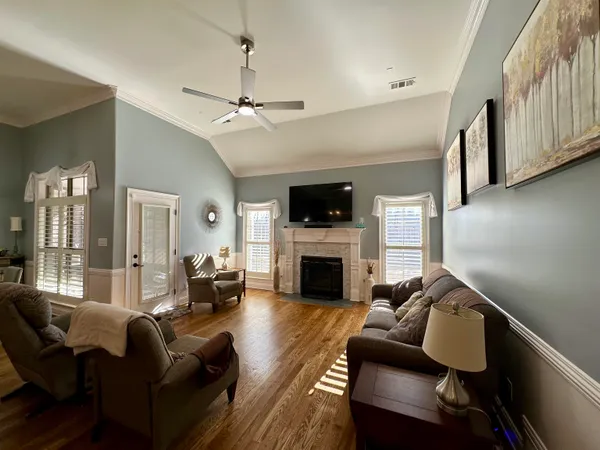 a kitchen with sink stove and wooden floor