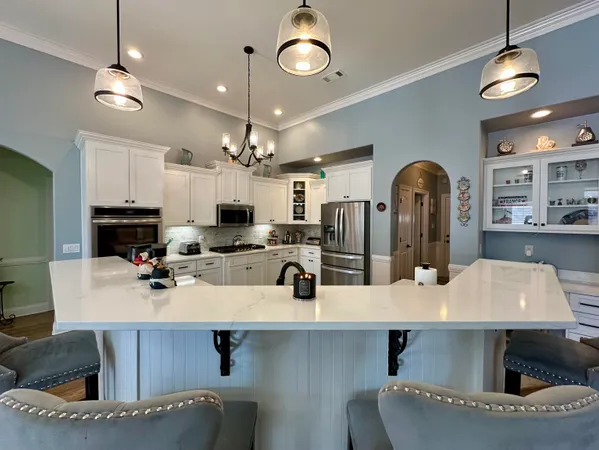 a kitchen with a table chairs and white cabinets