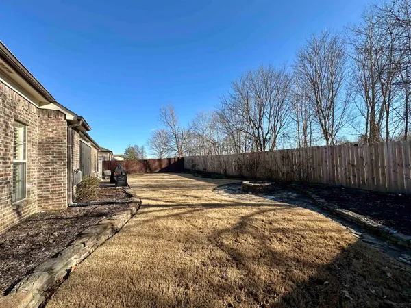a view of street with wooden fence