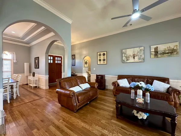a living room with furniture and wooden floor